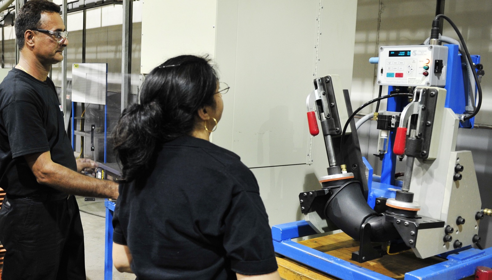 Novo Plastics team members operating production equipment